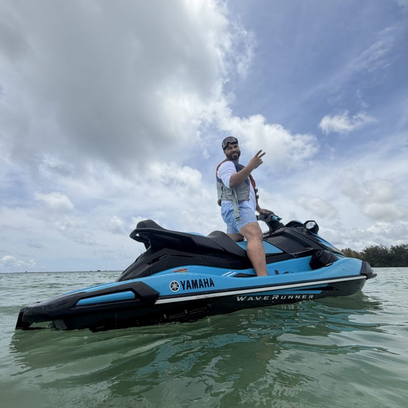 man on blue jet ski